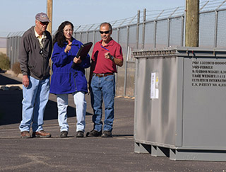 HOWARD SEELEY, left, Linda Gonzales, and Leroy Duran (all 4144), review a recent shipment of waste items bound for the Nevada National Security Site (NNSS). The three are members of Sandia’s Waste Management and Pollution Prevention team, which this summer wrapped up a project with the United States Air Force to transfer excess nuclear materials from a site in Alaska to the NNSS. (Photo by Randy Montoya)