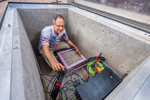 Tim Draelos inspects a seismic sensor 