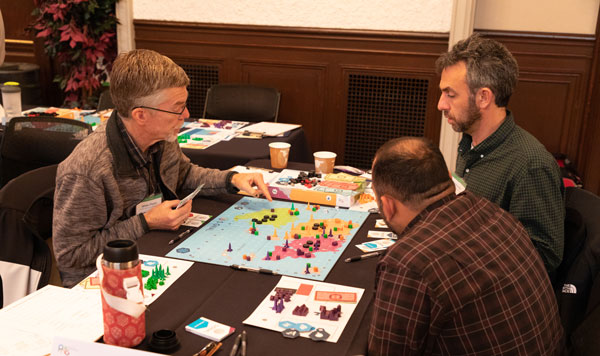 group of players examine game board