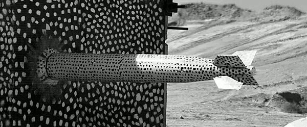 Caption: A B61-12 test unit slams into a target at the end of Sandia’s 10,000-foot rocket sled track in a complex forward ballistics test. The test, which mimicked a high-speed accident, allowed engineers to examine safety features inside the weapon. (Photo courtesy of Sandia Photometrics)