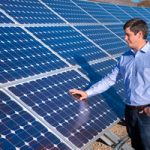 engineer inspects solar panels