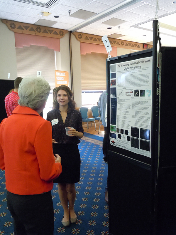 Anne Noonan (8631), a summer undergraduate intern from Carnegie Mellon University, explains her biology poster to Margaret Quinn (3555), manager of Recruiting and Student Programs. (Photo by Dani Martinez)