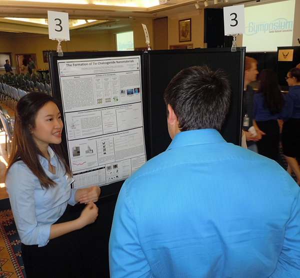 Thao Nguyen (1815), a summer high school student intern, explains her materials science poster. (Photo by Dani Martinez)