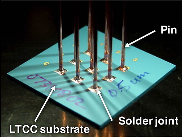 TEST SPECIMEN — Researchers used the novel test specimen pictured here for the work behind an award-winning paper that evaluated the mechanical properties of solder joints made to a thin film conductor pattern deposited on a low temperature co-fired ceramic substrate. (Photo courtesy of Paul Vianco)