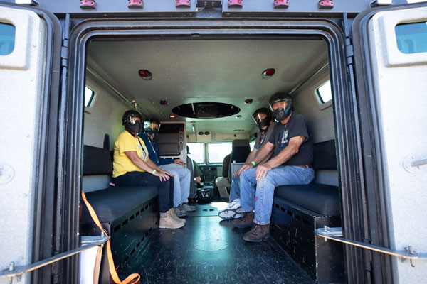 Rescued hostages wait in the BearCat armored vehicle.