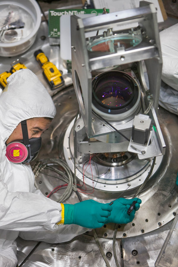 scientist makes adjustment to hardware inside Z line VISAR chamber