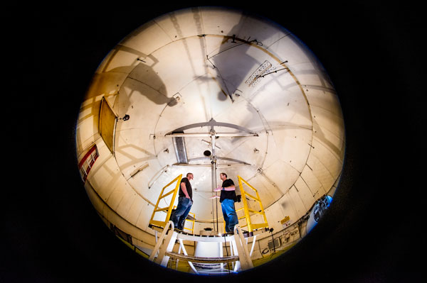 technologists discuss test installation in the high altitude chamber