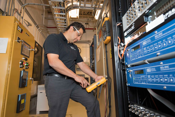 ENERGY BOOST — Manager Abraham Ellis works in Sandia’s Distributed Energy Technologies Laboratory. Ellis is a lead researcher on the Cooperative Research and Development Agreement with Emera Technologies Ltd. (Photo by Randy Montoya)