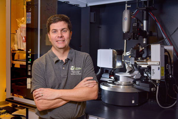 SEEING INSIDE — Mark Rodriguez, HENAAC Luminary, poses with one of his favorite instruments, the Single Crystal X-ray Diffractometer in the Sandia X-ray laboratory.