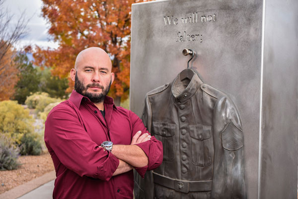ROAD TO SANDIA — Supply Chain subcontract manager Matt Leyva stands by the War on Terror Kiosk at the New Mexico Veterans’ Memorial in Albuquerque. Prior to working at Sandia, he served as a Marine for six years, was a professional fighter, and a stuntman in films shot in New Mexico.