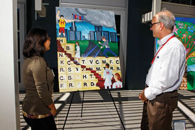 ÒHydrogen Man vs. Carbo,Ó created by Jazmin Vital (on left) and Carlos Hernandez Reyes, caught the attention of many hydrogen researchers, including Tom Felter (8252), manager of hydrogen and metallurgy research.	(Photo by Randy Wong)