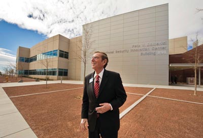 BUILDING A LEGACY Ñ In a quiet moment amid the festive hubbub of the day, former New Mexico Sen. Pete Domenici pauses in front of the building named in his honor. Domenici, joined by members of his family, received plaudits from Sandia and NNSA for his long-time support for the nuclear weapons program and NNSAÕs national security enterprise.	 (Photos by Randy Montoya)