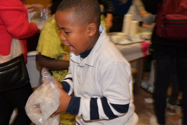 WE ALL SCREAM FOR ICE CREAM — It’s tough to tell whether this student was just excited by the prospect of eating the ice cream he is making here, or if his hands were also freezing.