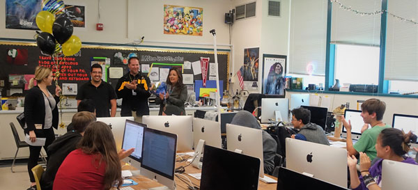 SURPRISE — Granada High School students try to figure out why principal P.J. Daley (second from right) and school superintendent Kelly Bowers (right) had entered their classroom as their teacher Miguel Baez (second from left) is surprised with the 2018 Sandia National Laboratories Excellence in Teaching Award. (Photo courtesy of Sandia National Laboratories)