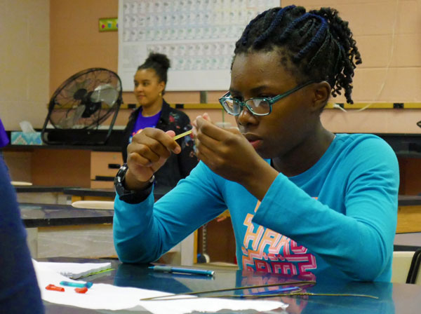 UNDERSTAND MECHANICAL PROPERTIES — A student uses rubber bands, ice-pop sticks, paper clips and a wire hanger to illustrate the elastic and plastic regions on the stress and strain curve and to characterize each material failure as ductile or brittle. (Photo by Lindsey Kibler)
