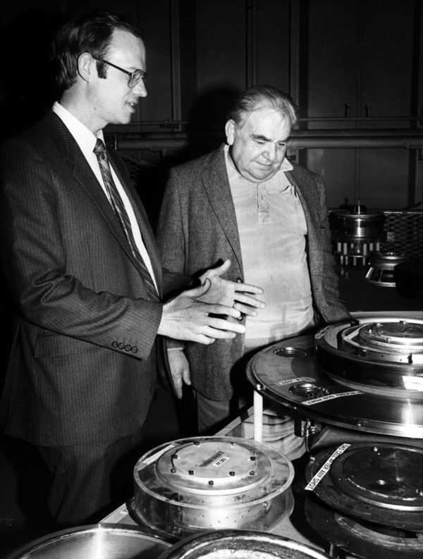 IONIC AND ICONIC — In a 1985 file photo, VanDevender explains the ion diodes of PBFA II to Adam Klein, counsel and chief staff member for the House Armed Services Committee. (Photo from A History of Exceptional Service in the National Interest)
