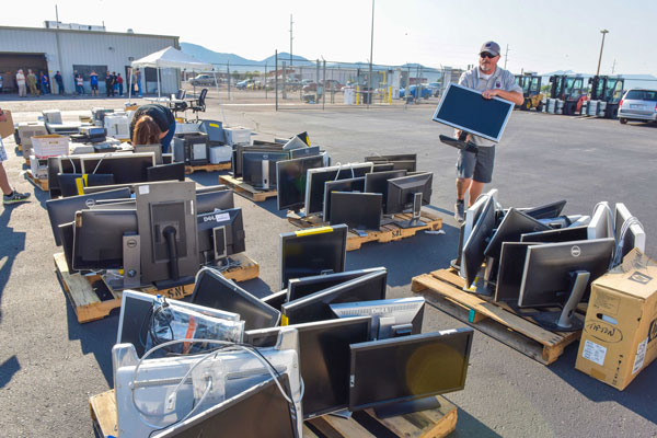 SCREEN TIME — Keith Legoza of El Camino Real Academy in Albuquerque was one of more than 40 school representatives who collected monitors and printers during the K-12 Computer Donation Event held at Reapplication. Sandia’s supply chain team works with schools to determine their needs ahead of the event.