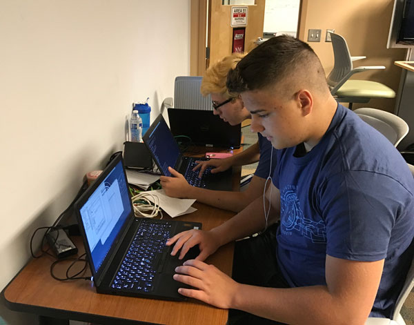 ADVANCED SKILLS — Camp participants work to solve a cybersecurity challenge. Cybercamp was held at the Cyber Engineering Research Laboratory located in the Sandia Science and Technology Park in Albuquerque.