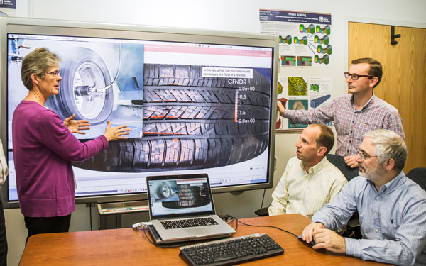 TOP TEAM — Computer scientists (left to right) Vicki Porter, Byron Hanks and Antonio Recuero from Sandia and Mohammed Sobhanie of The Goodyear Tire & Rubber Co. study images of tire technology. (Photo by Jennifer Plante)