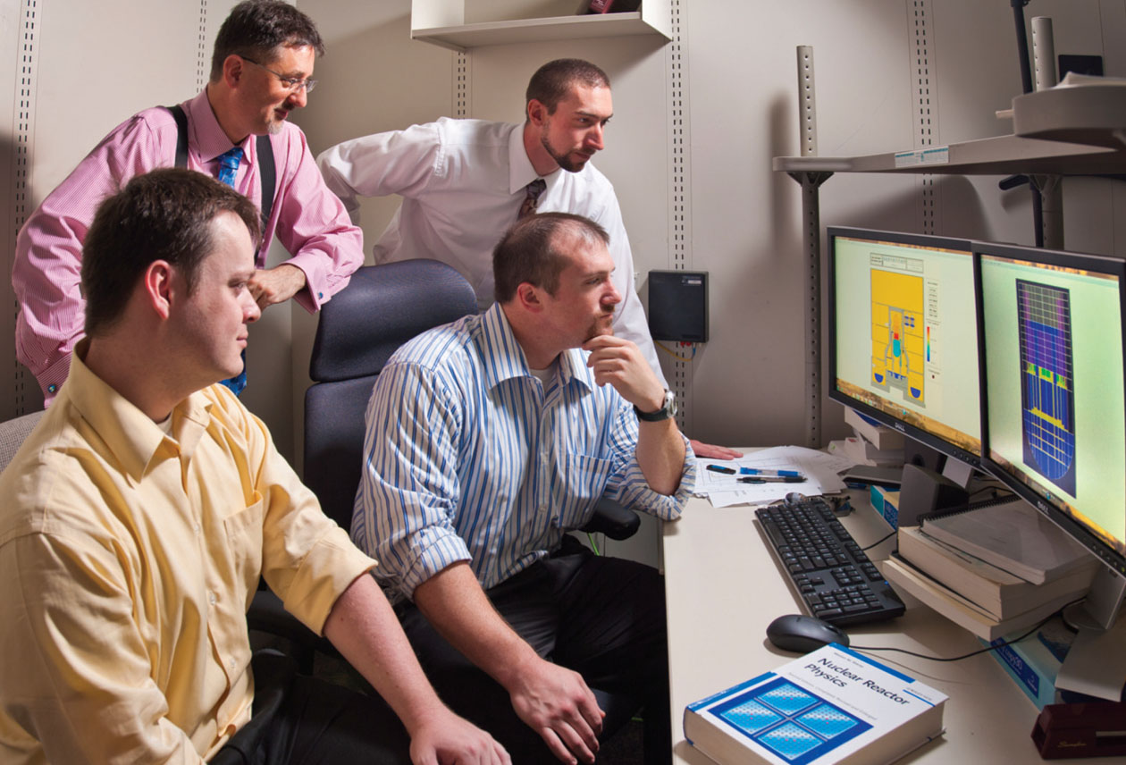 SANDIAN RESEARCHERS Don Kalinich, left rear, Andrew Goldmann, right rear, Jesse Phillips, left front, and Jeffrey Cardoni have used the Sandia-developed MELCOR code to analyze the 2011 Fukushima Daiichi reactor accident.	(Photo by Randy Montoya)