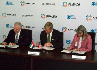 RESPONSIBLE NUCLEAR DEVELOPMENT — Div. 6000 VP Jill Hruby signs a memorandum of understanding with Raymond Juzaitis, head of the nuclear engineering program at Texas A&M University, left, and Tod Laursen, president of the Khalifa University of Science, Technology and Research in Abu Dhabi, that establishes the Gulf Nuclear Energy Infrastructure Institute. (Photo by Scott Struve)