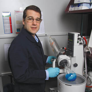 IRON MAN Ñ Dale Huber, working with retired Los Alamos National Laboratory researcher Ed Flynn and his company, Senior Scientific LLC, is using the tools of nanotechnology to grow nanoscopic iron oxide particles as part of an approach to provide early detection of cancer cells.	 The blue material here is a solution of cobalt chloride, a salt that can be used as  a precursor to magnetic nanoparticles.	(Photo by Lloyd Wilson)