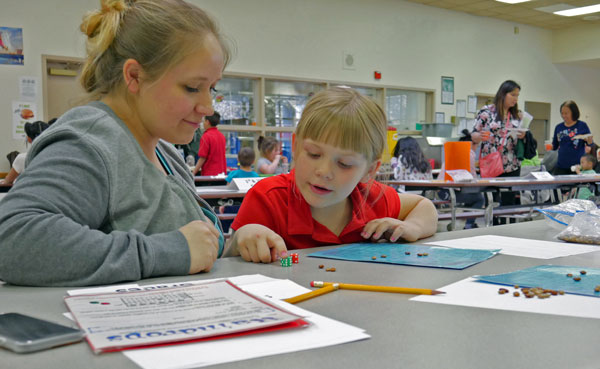 MOTHER AND DAUGHTER — Second grader Ariel Jaskolski and her mother work together on an activity, March 14. Ariel said she loves math and science and was excited her mom was able bring her to the event at Tomasita Elementary School.