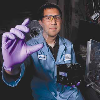 Image of <p>DISK JOCKEY — Ulrich Schaff holds a prototype SpinDx, a portable instrument for running assays for toxins and other substances. The SpinDx botulinum assay outperformed the current 