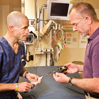 MAKING THE CUT — Sandia researcher Mark Reece, right, and Albuquerque emergency room physician Scott Forman examine trauma shears developed for Forman’s company, Héros, under a New Mexico Small Business Assistance Program project. (Photo by Randy Montoya)