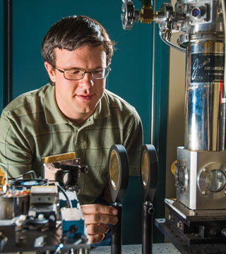 Caption: GREG DYER (1118) is co-principal investigator of a Sandia-led team that has created a plasmonic, or plasma-containing, crystal that is tunable by adjusting the voltage applied to it. The technology potentially could increase the bandwidth of high-speed communication networks. Read the story on page 5.	(Photo by Randy Montoya)