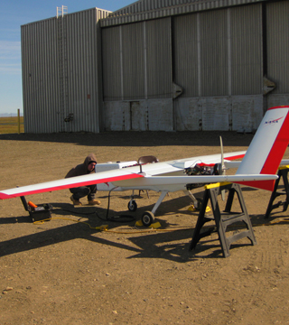 Image of <p>Research team members prepare the Sierra unmanned aerial system for flight from Oliktok Point. (Photo by Mark Ivey)</p>