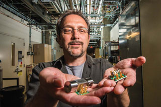 Ron Manginell and colleagues are developing new miniature pulsed-discharge ionization detectors — mini-PDIDs — like those Ron is holding here. The tiny devices have broadened the scope of chemical targets for Sandia’s microanalytical detection technology to toxic industrial chemicals, biological volatiles, greenhouse gases, and more. (Photo by Randy Montoya)