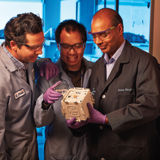 SPIN DOCTORS — From left,Sandia’s Matt Piccini (8621), Chung-Yan Koh (8621), and Anup Singh (8620) lead the SpinDx team. The hope is that a new NIH-funded project that takes advantage of SpinDx technology will take the device to a new level and result in a point-of-care instrument that can detect a suite of biothreat agents. (Photo by Jeff McMillan)