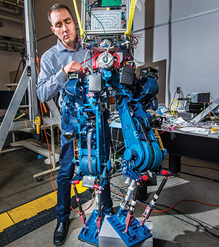 Steve Buerger (6533) is leading a Sandia project to demonstrate how energy efficient biped walking robots could become. Increased efficiency could enable bots to operate for much longer periods of time without recharging batteries, an important factor in emergency situations.	(Photo by Randy Montoya)