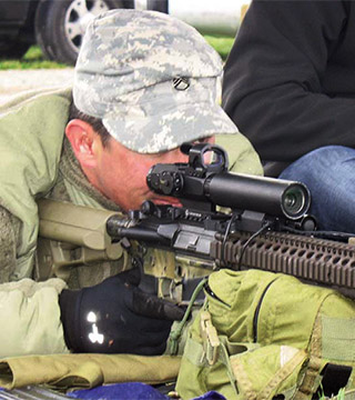 A member of the US Army Special Forces, left, demonstrates the Rapid Adaptive Zoom for Assault Rifles prototype developed at Sandia National Laboratories.