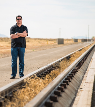 ON THE RIGHT TRACK — Sandia engineer and project manager Michael J. Vigil (1533) is part of a team that oversees tests done at the 10,000-foot rocket sled track. The wiring systems on the track were completely rebuilt during the Test Capabilities Revitalization. (Photo by Randy Montoya)