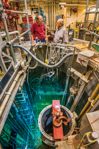 Image of <p>Dick Coats, right, Eden Radioisotopes’s chief technology officer and a retired Sandian, talks science with nuclear engineer John Ford  (1381) at the Annular Core Research Reactor, where they helped develop a molybdenum-99 reactor concept in the 1990s. Eden recently licensed the technology with the goal of producing a US supply of moly 99 for use in nuclear medicine. (Photo by Randy Montoya)</p>