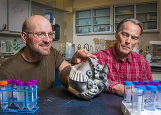 Image of <p>PAT BRADY AND BOB McKINNON look over a state-of-the-art drill bit used in deep boreholes. (Photo by Randy Montoya)</p>