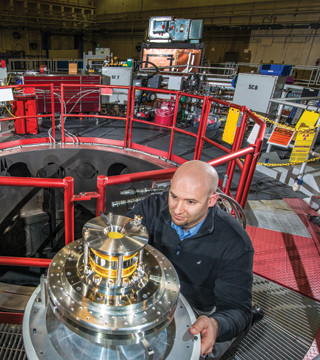 A Moment of Awe — Sandia physicist Tom Awe (1688) examines coils that reduce plasma instabilities in the quest for controlled nuclear fusion at Sandia's Z machine. (Photo by Randy Montoya)