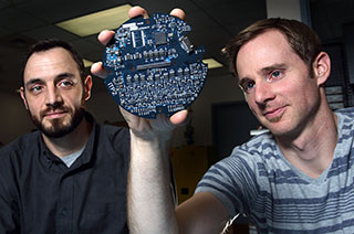 WEAPON PERFORMANCE DATA COLLECTORS — Brett Chavez and Jerrod Peterson (both 8135) build and test high-performance instrumentation systems for ground and flight tests.	(Photo by Dino Vournas)