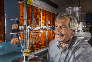 Image of <p>THE SUN NEVER LOOKED SO CLOSE — Physicist Jim Bailey observes a wire array that will heat foam to roughly 4 million degrees until it emits a burst of X-rays that heats a foil target to the interior conditions of the sun. Working at Sandia’s Z machine, Jim and his team have been able to determine experimentally, for the first time in history, iron’s role in inhibiting energy transmission from the center of the sun to near the edge of its radiative band.      (Photo by Randy Montoya)</p>