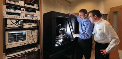 VETERAN AND SMALL BUSINESS owner Tracy Solomon, right, of TEVET LLC, and Kent Childs (1748) look over some equipment that Solomons company supplied to Sandia. (Photo by Randy Montoya)