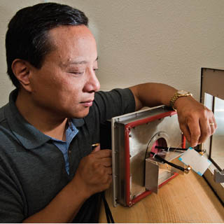 MATERIALS SCIENCE RESEARCHER Steve Dai (1832) has come up with a unique approach to creating materials whose properties wonÕt degenerate when temperatures swing.	(Photo by Randy Montoya)