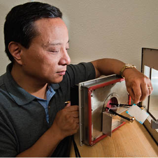 MATERIALS SCIENCE RESEARCHER Steve Dai (1832) has come up with a unique approach to creating materials whose properties won’t degenerate when temperatures swing. (Photo by Randy Montoya)