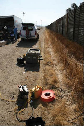 Image of <p>RESEARCHERS DEPLOY instruments for a seismic data acquisition survey parallel to the border fence in Otay Mesa, Calif. Some acquisition equipment including an SUV-mounted accelerated weight drop to generate seismic waves are shown in the photo.</p>