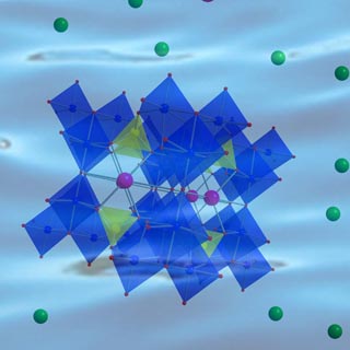 . The blue structure is a stylized crystalline silico-titanate, or CST. The magenta spheres are radiocesium ions in water and are being preferentially taken up by the CSTs over the green sodium ions. Sandia's CST work was recognized recently with a Federal Laboratory Consortium regional award.