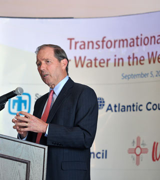 Image of <p class="wp-caption-text">N.M. Sen. Tom Udall, in opening remarks at the water roundtable, called for better coordination among large-scale water users, better sensors to detect water leaks as they happen or even before, and more research to determine the limits to Southwestern population growth. (Photo by Randy Montoya)</p>