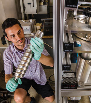 Image of <p>Ivan Ermanoski works on a room temperature prototype of the packed particle bed reactor for solar-thermochemical hydrogen production. (Photo by Randy Montoya)</p>