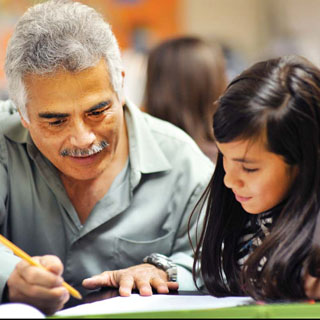 Salvador “Sal” Rodriguez (1532) works with a student during the inaugural session of this year's Manos program. (Photo by Randy Montoya)