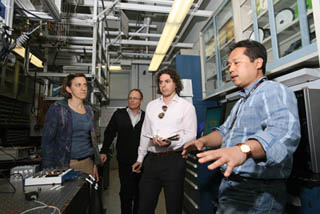 Sandia’s Daniel Soh, right, offers an overview of the continuous variable quantum key distribution (CV-QKD) laboratory for the Department of Homeland Security’s Mike Pozmantier (center, white shirt). Pozmantier, program manager for DHS’s Transition to Practice program in the department’s Cyber Security Division, visited Sandia/California recently to observe various cybersecurity projects at the lab and discuss Sandia’s test and evaluation role in TTP. (Photo by Dino Vournas)